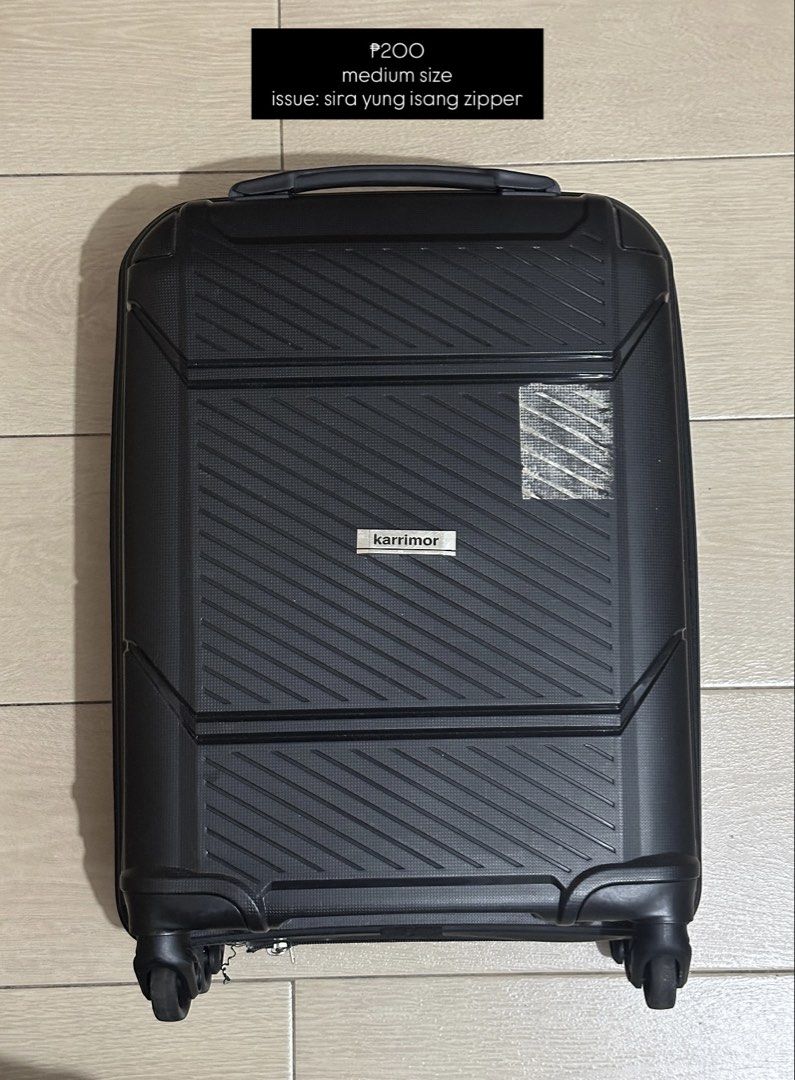 Karrimor Medium Black Luggage Suitcase (Category: Luggage) located in Mandaluyong City. Submitted by ireneangelinee (Listing ID 1466614349, Image 1). Description: - Brand: Karrimor - Color: Black - Size: Medium - Features: 4 smooth-rolling spinner wheels and a convenient top handle - Flaws: Sticky residue/tape mark on the front right side; zipper is broken - Price: Heavily discounted due to the zipper issue.