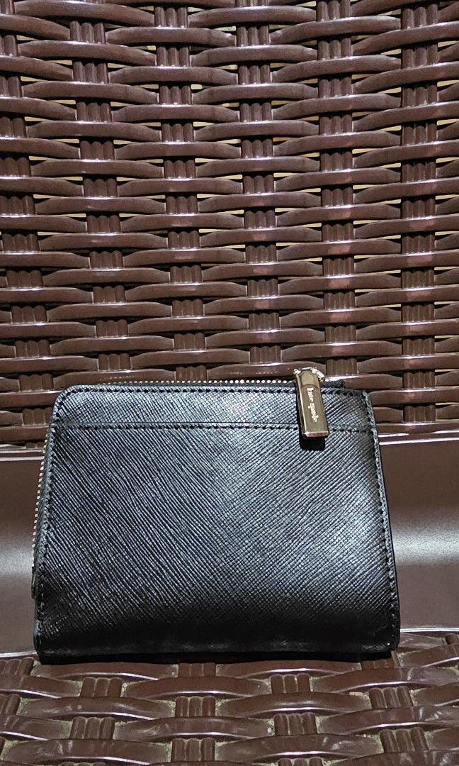 KATE SPADE SMALL L-ZIP WALLET (Category: Wallets & Card Holders) located in Taytay. Submitted by smallgoodiesph (Listing ID 1466638153, Image 3). Description: Measurements: Length: 4.8" Height: 3.7" Material: Saffiano Leather Features: Exterior slip pocket Interior ID window, 2 slip pockets, bill slot 5 interior credit card slots Snap closure L-Zip Coin Compartment Metal logo Dust Bag Included: No Deacription: Polished and compact, Kate Spade Sma