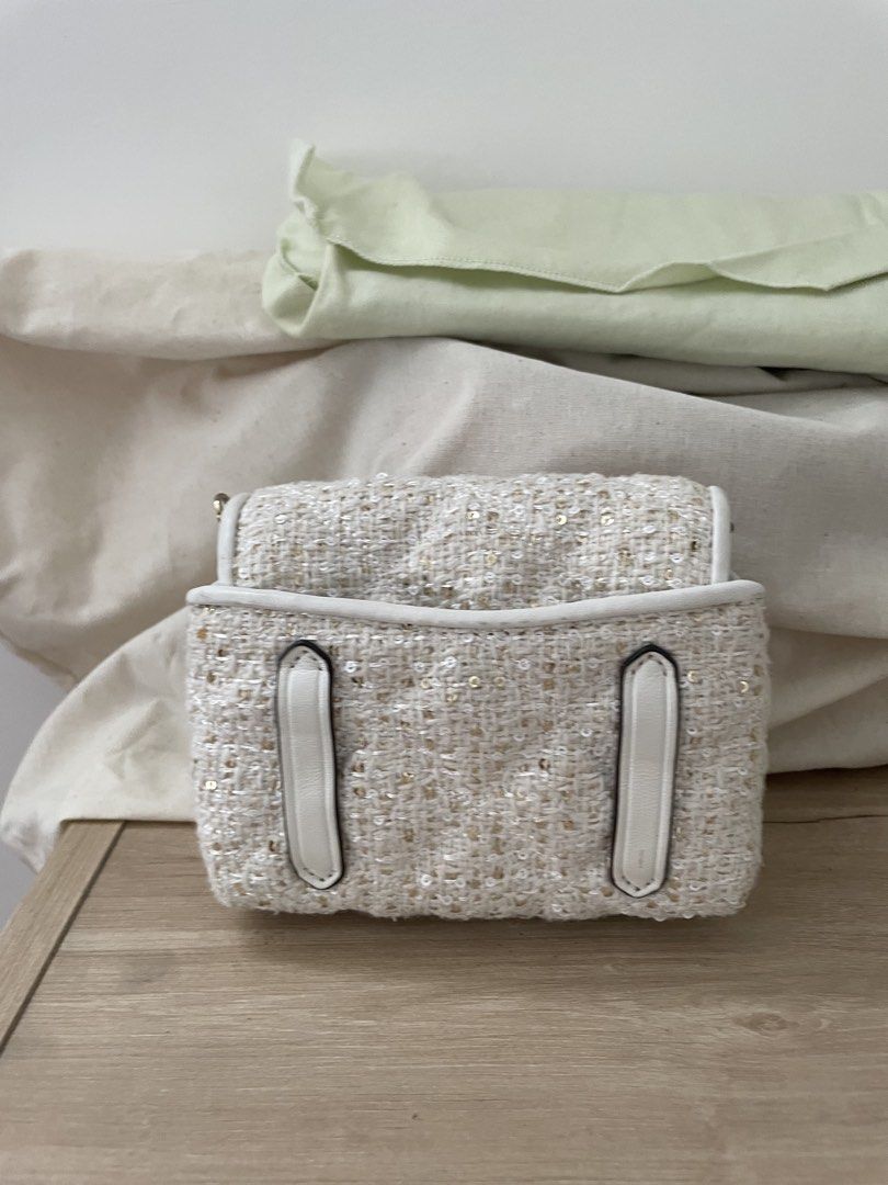 Kate Spade Tweed Sequins Crossbody Bag (Category: Cross-body Bags) located in Cordova. Submitted by fiercedragon.47e450 (Listing ID 1466604910, Image 3). Description: - Brand: Kate Spade - Material: White tweed with subtle sequins - Hardware: Gold-tone turnlock closure - Interior: White leather lining, logo stamp, and slip pocket - Style: Compact crossbody, perfect for evening wear.