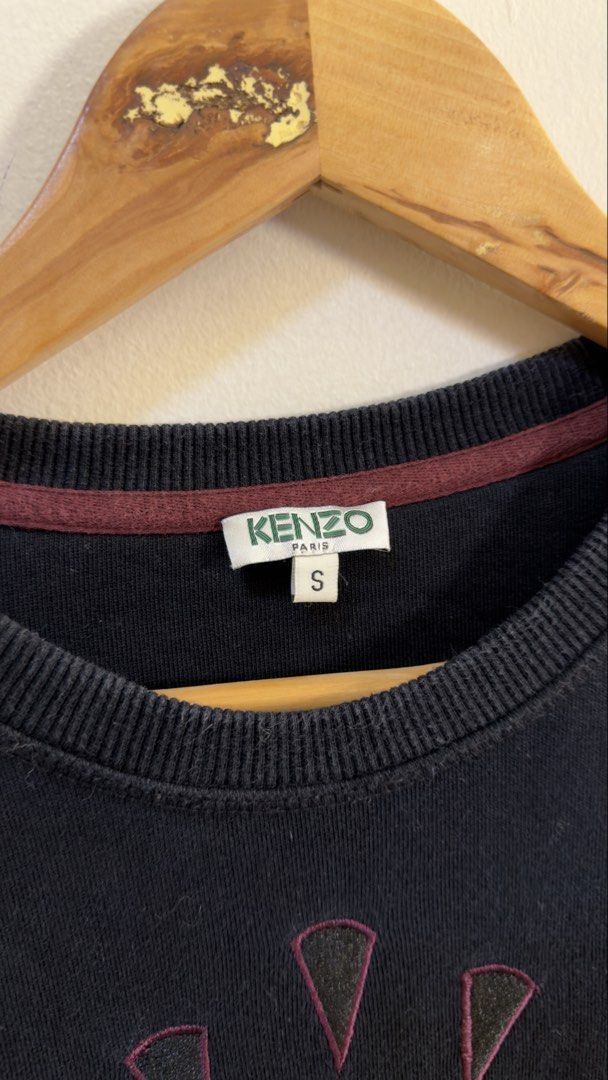Kenzo Paris Black Eye Sweatshirt Size S (Category: Coats, Jackets and Outerwear) located in Paranaque City. Submitted by preluxeshop_ph (Listing ID 1466769626, Image 3). Description: Kenzo Paris Black Eye Sweatshirt Size S - Color: Black with patterned sleeve stripes - Design: Iconic embroidered eye motif on chest - Size: Small (Regular fit) - Material: Premium cotton with soft fleece backing - Origin: Made in Portugal - Details: Ribbed crewneck 