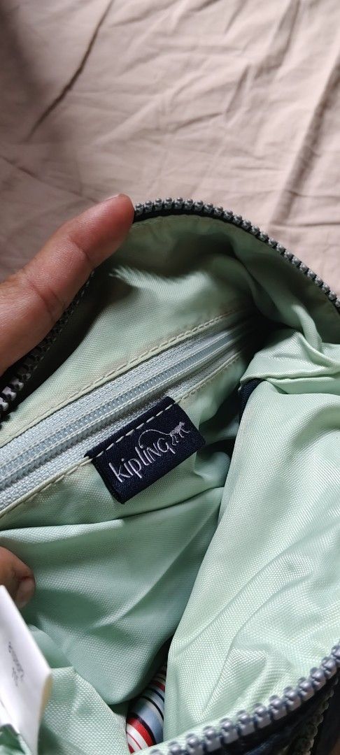 Kipling Alvar Crossbody Bag Dark Blue (Category: Cross-body Bags) located in Manila. Submitted by roserallos42594 (Listing ID 1466592431, Image 3). Description: - Brand: Kipling - Color: Dark blue nylon with light green interior lining - Inclusions: Matching fuzzy monkey keychain named Mati - Compartments: Multiple exterior zipped pockets for secure storage - Strap: Adjustable thick fabric shoulder strap for comfortable wear - Condition: Excellen