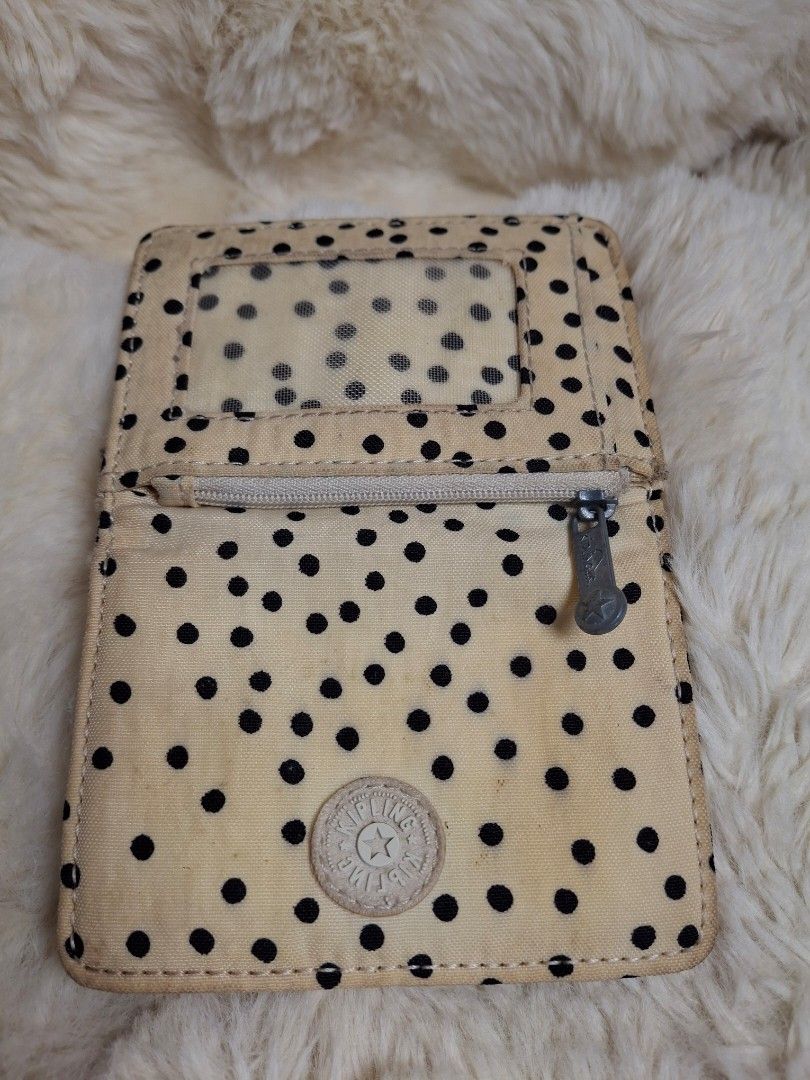 Kipling polka dot wallet with coin zipper (Category: Wallets & Card holders) located in Rizal. Submitted by emskititay (Listing ID 1466680948, Image 1). Description: Kipling Vintage atm/coin purse ₱850 ●Small atm/ coin wallet ●used heavily ●7/10 color condition ●polkadots black cream ●L 8 cm x W 11 cm xH 1cm ●Have some yellowish stains due to aging Location: Taytay Rizal 💼Rfs Decluttering my Kipling collections.
