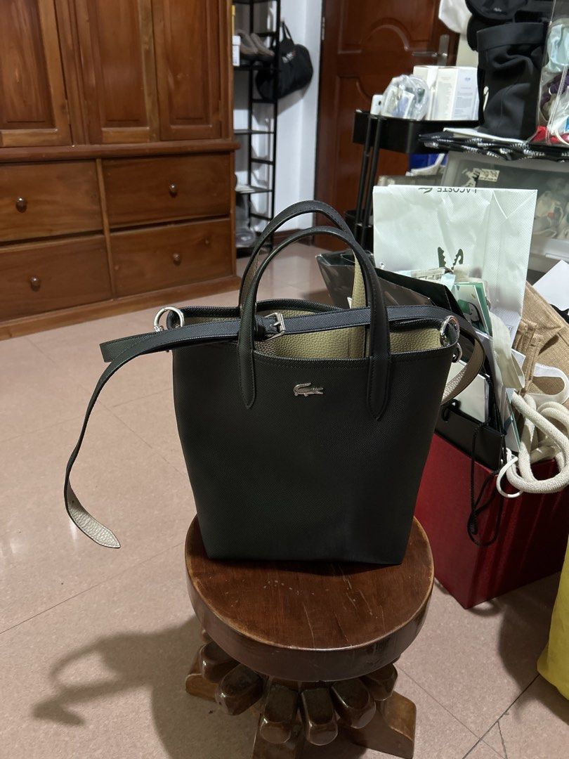 Lacoste Black and Beige Tote Bag (Category: Tote Bags) located in Alitagtag. Submitted by patrickvillanueva (Listing ID 1466626633, Image 3). Description: - Brand: Lacoste - Color: Black and beige - Material/Design: Structured textured exterior with silver-tone crocodile logo hardware - Straps: Dual top handles plus an adjustable, detachable shoulder strap - Interior: Beige pebble grain texture lining with an open compartment - Condition: Clean s