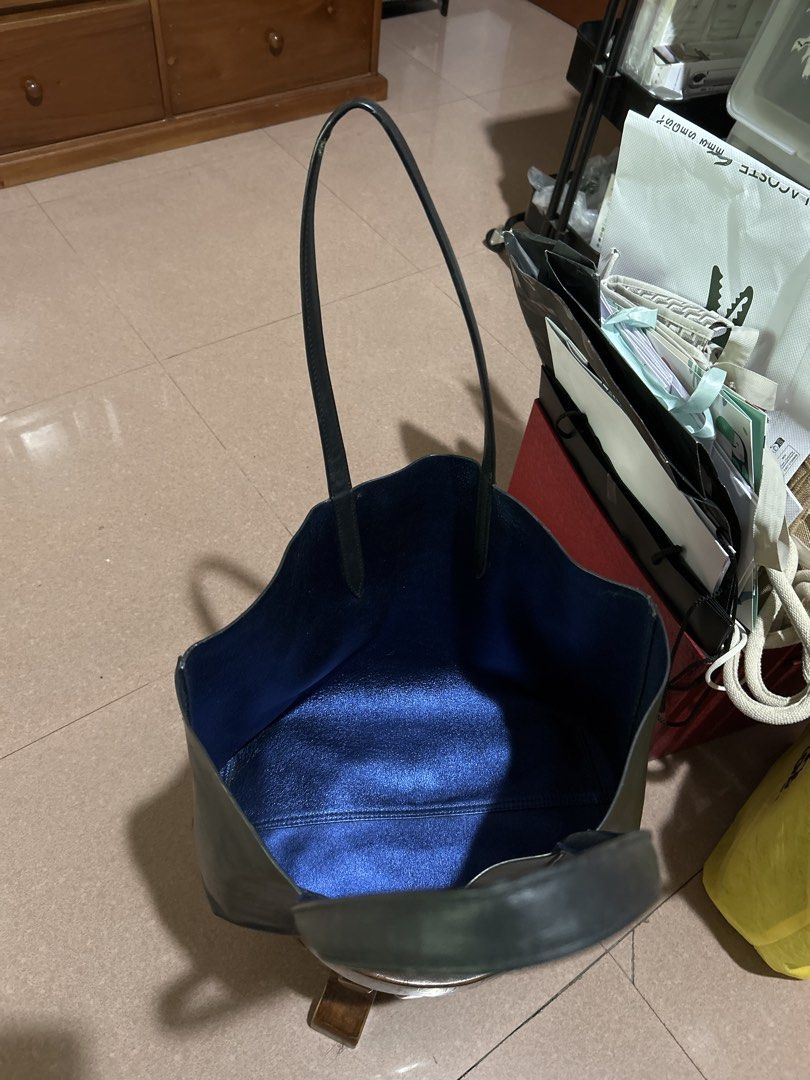 Lacoste Black Pure Leather Tote Bag (Category: Tote Bags) located in Alitagtag. Submitted by patrickvillanueva (Listing ID 1466619279, Image 2). Description: I bought this for ₱18,000+ at Lacoste Solaire. - Brand: Lacoste - Color: Black exterior with a contrasting metallic blue interior - Material: Genuine leather - Design: Minimalist style with front embossed crocodile logo, dual shoulder straps, and open top - Condition: Good, with minor scuffs