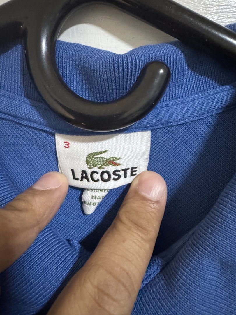Lacoste Blue Polo Shirt Size 3 (Category: Tshirts & Polo Shirts ) located in Makati City. Submitted by mackyquintos (Listing ID 1466591949, Image 2). Description: - Brand: Lacoste - Color: Blue - Size: 3 (Classic Fit) - Design: Two-button placket, ribbed collar and cuffs - Logo: Iconic embroidered green crocodile on left chest - Condition: Clean fabric, no noticeable flaws - Style: Casual short sleeve.