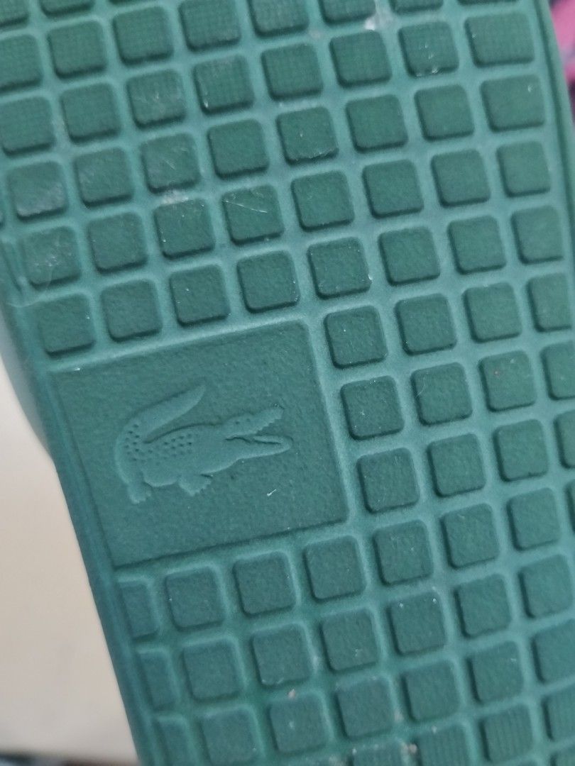 Lacoste Green Slides Sandals (Category: Slippers & Slides) located in Bulacan. Submitted by cjcshop22 (Listing ID 1466596218, Image 3). Description: - Brand: Lacoste - Color: Green with signature white crocodile logo - Condition:Excellent - Features: Comfortable textured grid footbed, easy slip-on style Original Lacoste Sleeper Original Lacoste sleeper, purchased from Solaire. Labeled size 9, but due to being exposed to sunlight over time, the ma