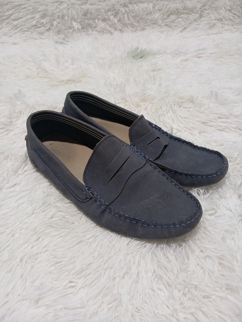 Lacoste Loafers (Category: Casual Shoes) located in Quezon City. Submitted by thesecondmarketph (Listing ID 1466758358, Image 1). Description: - Brand: Lacoste - Color: Navy blue - Style: Slip-on penny driver loafers with contrast stitching - Sole: Brown rubber pebble sole wrapping up the heel - Usage: Comfortable flat shoes, perfect for daily casual outfits.