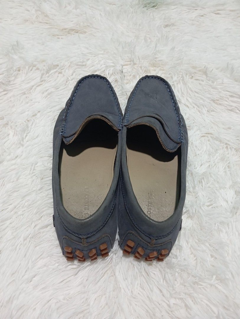 Lacoste Loafers (Category: Casual Shoes) located in Quezon City. Submitted by thesecondmarketph (Listing ID 1466758358, Image 3). Description: - Brand: Lacoste - Color: Navy blue - Style: Slip-on penny driver loafers with contrast stitching - Sole: Brown rubber pebble sole wrapping up the heel - Usage: Comfortable flat shoes, perfect for daily casual outfits.