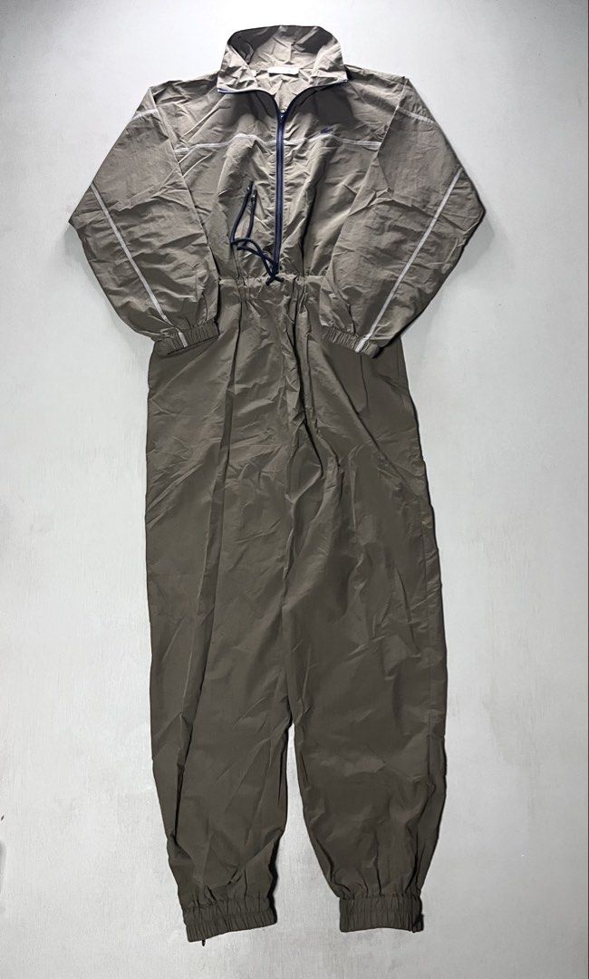 Lacoste Olive Green Nylon Jumpsuit Size 36 (Category: Jumpsuits) located in Catbalogan. Submitted by yellfindss (Listing ID 1466744324, Image 1). Description: - Brand: Lacoste - Style: Olive green lightweight nylon jumpsuit with stand collar - Size: 36 - Features: Full zip closure, adjustable drawstring waist, and ribbed cuffs at ankles and wrists - Details: Chic contrast white stitching on chest and sleeves with signature embroidered crocodile l
