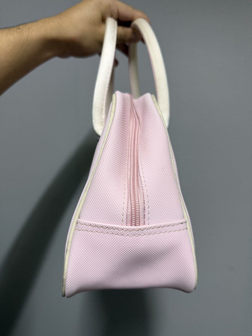 Lacoste Pink Handbag (Category: Luxury Bags & Wallets) located in Baguio. Submitted by truevintagelux_ph (Listing ID 1466731216, Image 2). Description: - Authentic pink Lacoste handbag with stylish white handles and piping trim - Features a subtle debossed crocodile logo on the lower right corner - Dual metal zipper closure with Lacoste-engraved pull tabs - Made of durable, structured canvas-like material with a flat, clean bottom base - Spacious