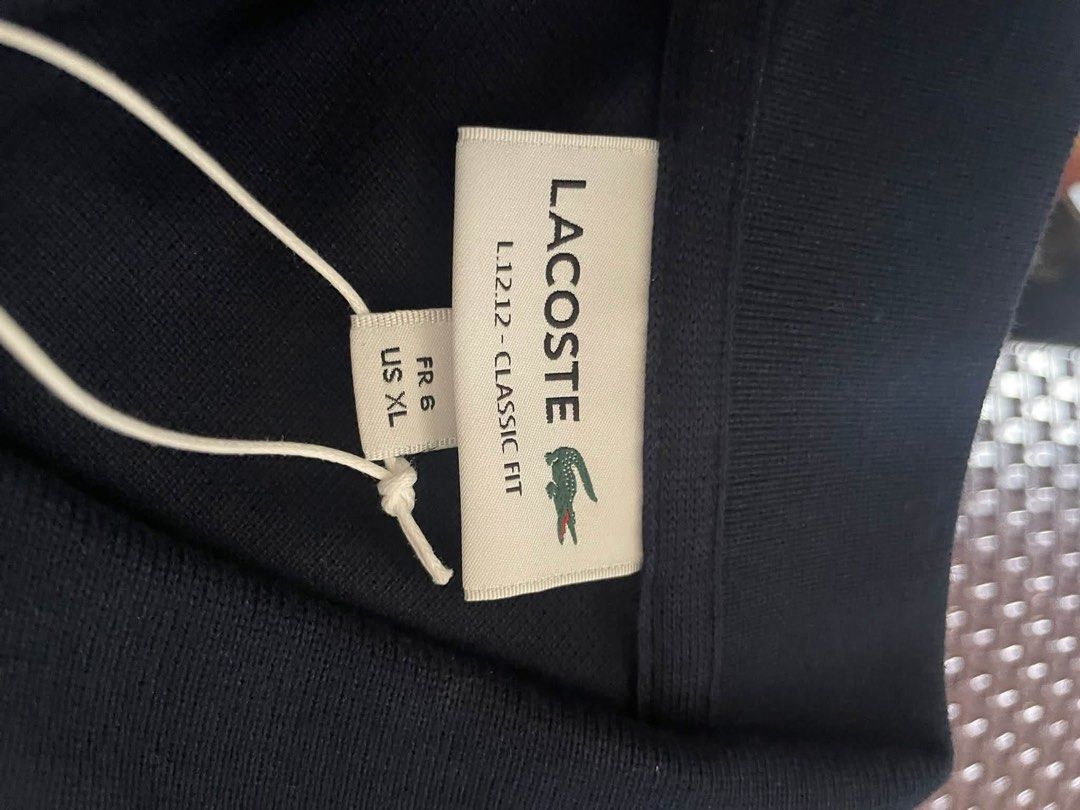 Lacoste Polo Shirt (Category: Tshirts & Polo Shirts ) located in Quezon City. Submitted by _gg06 (Listing ID 1466668602, Image 2). Description: - Brand: Lacoste L.12.12 Classic Fit Polo Shirt - Color: Navy Blue - Size: FR 6 / US XL - Material: 100% Cotton - Condition: Brand new, never worn - Inclusions: Original store tags attached and plastic packaging included RFS: Wrong size. Bought in Lacoste store, Iconsiam Bangkok. .