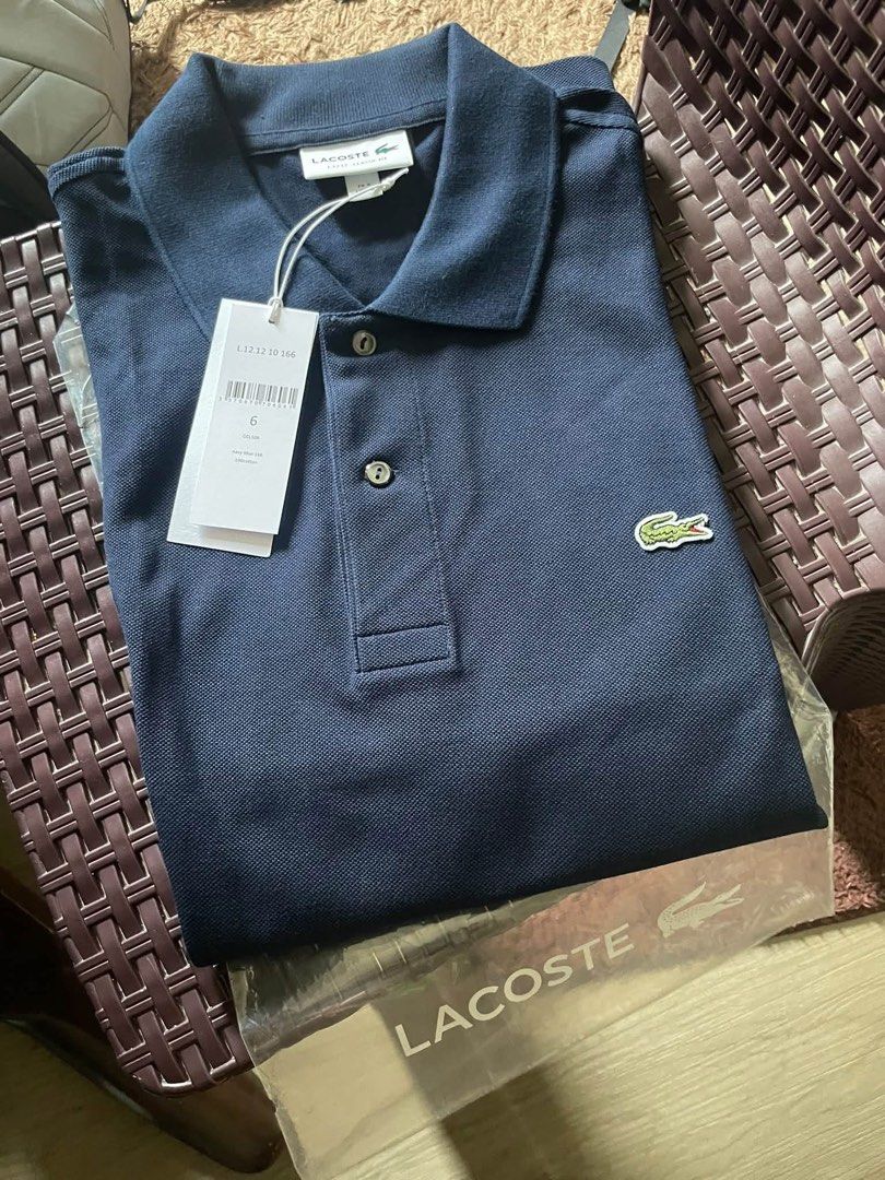 Lacoste Polo Shirt (Category: Tshirts & Polo Shirts ) located in Quezon City. Submitted by _gg06 (Listing ID 1466668602, Image 1). Description: - Brand: Lacoste L.12.12 Classic Fit Polo Shirt - Color: Navy Blue - Size: FR 6 / US XL - Material: 100% Cotton - Condition: Brand new, never worn - Inclusions: Original store tags attached and plastic packaging included RFS: Wrong size. Bought in Lacoste store, Iconsiam Bangkok. .