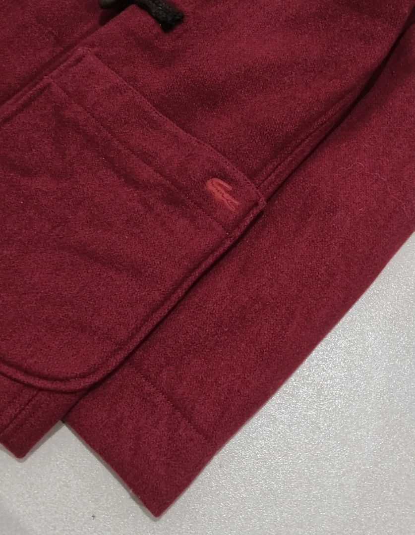 Lacoste Red Wool Blend Duffle Jacket Size 38 (Category: Coats, Jackets and Outerwear) located in Baguio. Submitted by re_cycle2600 (Listing ID 1466705159, Image 3). Description: - Brand: Lacoste - Color: Red - Size: 38 (fits true to size) - Material: 66% wool, 30% polyester, 4% other fibres - Design: Classic duffle style with hood, toggle closures, and two large front pockets - Detail: Iconic embroidered crocodile logo on the left pocket - Condit