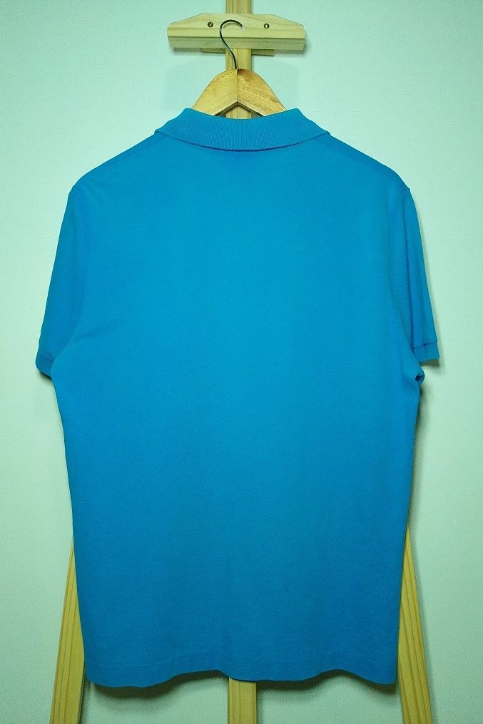 Lacoste Turquoise Blue Polo Shirt (Category: Tshirts & Polo Shirts ) located in Manila. Submitted by patrickjos06722 (Listing ID 1466715466, Image 2). Description: - Brand: Lacoste - Color: Bright Turquoise - Condition: good, with minor fades on the neck line and a little loose sleeve cuffs - Details: Classic two-button placket with white buttons, ribbed collar and sleeve cuffs, embroidered green crocodile logo - Chest (pit-to-pit): ~20 inches - 