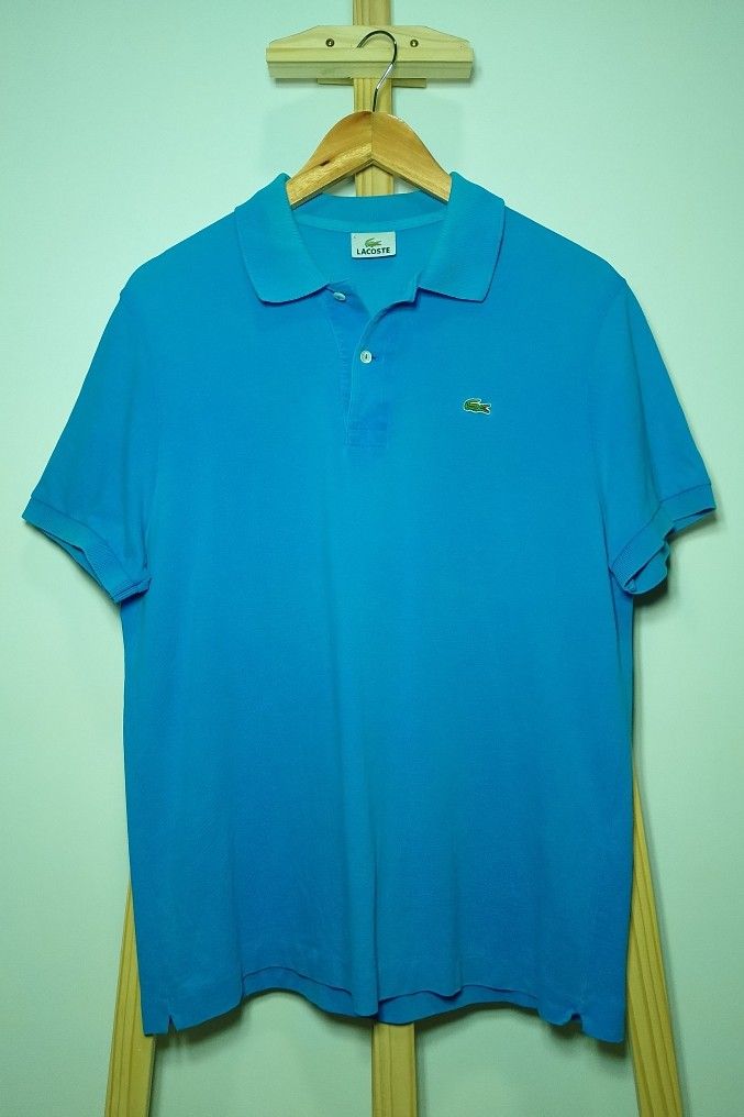 Lacoste Turquoise Blue Polo Shirt (Category: Tshirts & Polo Shirts ) located in Manila. Submitted by patrickjos06722 (Listing ID 1466715466, Image 1). Description: - Brand: Lacoste - Color: Bright Turquoise - Condition: good, with minor fades on the neck line and a little loose sleeve cuffs - Details: Classic two-button placket with white buttons, ribbed collar and sleeve cuffs, embroidered green crocodile logo - Chest (pit-to-pit): ~20 inches - 