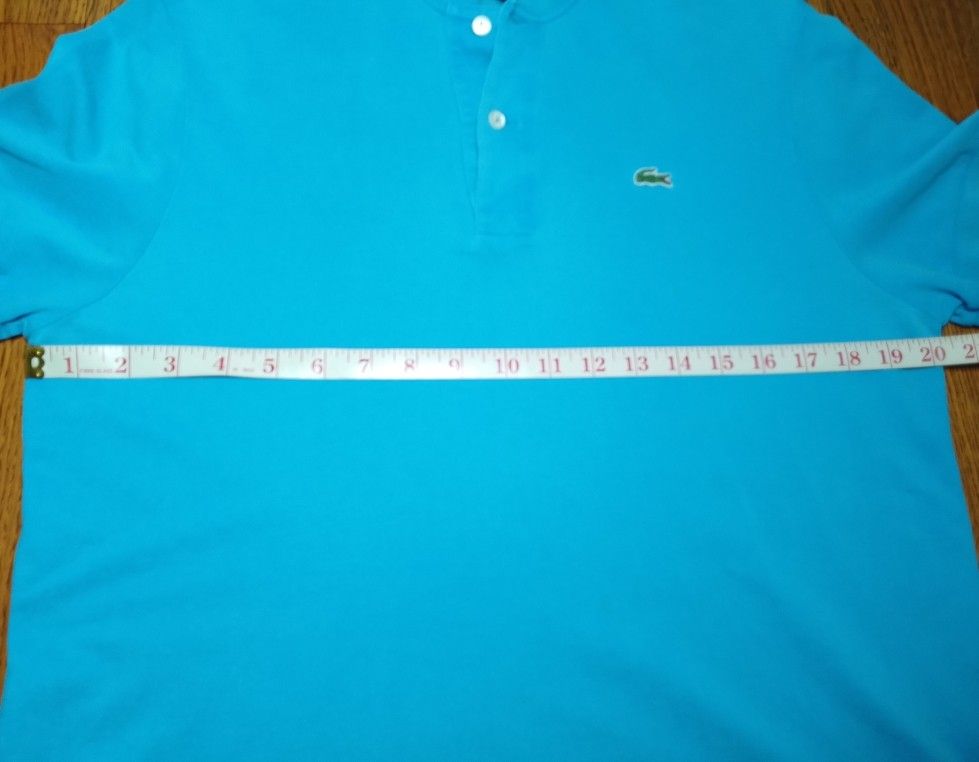 Lacoste Turquoise Blue Polo Shirt (Category: Tshirts & Polo Shirts ) located in Manila. Submitted by patrickjos06722 (Listing ID 1466715466, Image 3). Description: - Brand: Lacoste - Color: Bright Turquoise - Condition: good, with minor fades on the neck line and a little loose sleeve cuffs - Details: Classic two-button placket with white buttons, ribbed collar and sleeve cuffs, embroidered green crocodile logo - Chest (pit-to-pit): ~20 inches - 