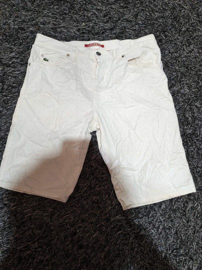 Lacoste White Denim Shorts (Category: Shorts) located in Laguindingan. Submitted by jingsuu22 (Listing ID 1466597318, Image 1). Description: - Brand: Lacoste - Color: White - Material: Denim - Closure: Button-fly with branded metallic buttons - Details: Small embroidered crocodile logo near the front pocket - Branding: Red LACOSTE brand label on the waistband - Fit/Style: Classic, versatile piece ideal for warmer weather.