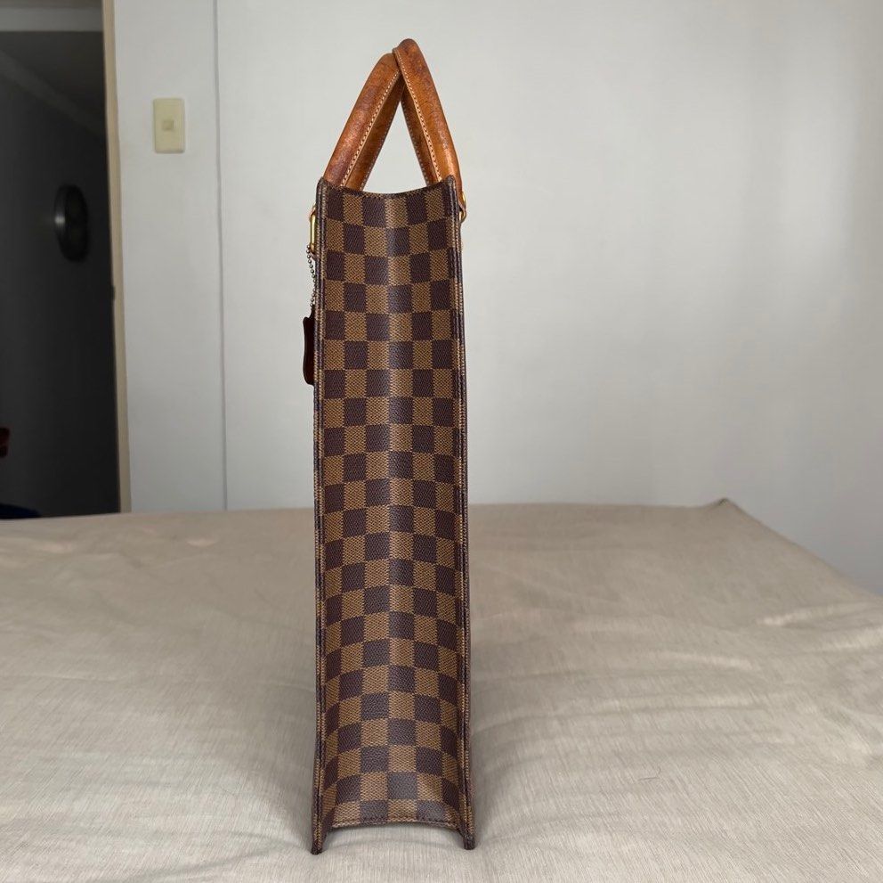 Le Sabbi Checkered Tote Bag (Category: Tote Bags) located in Pasig City. Submitted by jenscloset86 (Listing ID 1466614226, Image 2). Description: LE SABBI Tote Bag • Classic brown checkered. • Structured shape with flat base and side profile. • Gold hardwares in good condition. • Matching leather tag on a ball chain. • No scuff, no runs. Exterior is in excellent condition. • Dual top leather handles show noticeable wear. Measurement (in inches): 