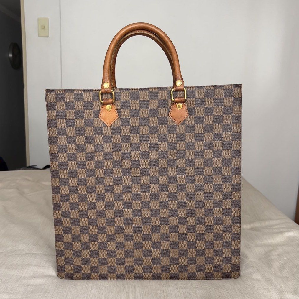 Le Sabbi Checkered Tote Bag (Category: Tote Bags) located in Pasig City. Submitted by jenscloset86 (Listing ID 1466614226, Image 3). Description: LE SABBI Tote Bag • Classic brown checkered. • Structured shape with flat base and side profile. • Gold hardwares in good condition. • Matching leather tag on a ball chain. • No scuff, no runs. Exterior is in excellent condition. • Dual top leather handles show noticeable wear. Measurement (in inches): 
