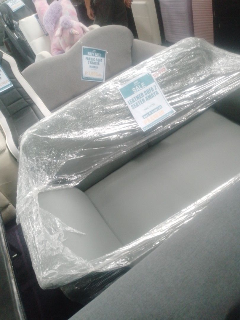 Leather Sofa 2 Seater Amaya Grey (Category: Sofas) located in Manila. Submitted by maryjane09. (Listing ID 1466592607, Image 2). Description: - Model: Amaya 2-Seater Leather Sofa - Color: Grey - Condition: Brand new, still wrapped in original store plastic - Features: Smooth upholstery, comfortable cushioning, space-saving size ideal for apartments and studios - Fulfillment: Ready for pickup or delivery arrangements.