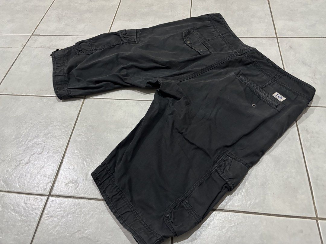 Lee Cargo Shorts Black Size 34 (Category: Shorts) located in Santa Rosa. Submitted by rahbii (Listing ID 1466565455, Image 2). Description: - Brand: Lee - Size: 34 - Color: Black with a stylish washed finish - Material: 100% durable cotton - Pockets: Multiple utility pockets on sides and back - Features: Adjustable buckle tabs at leg openings and branded hardware - Condition: Excellent, classic utility styling.