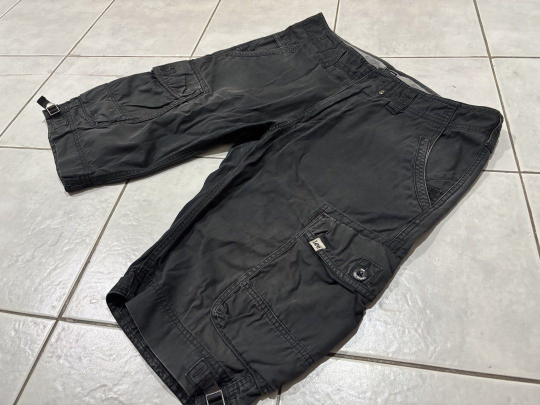 Lee Cargo Shorts Black Size 34 (Category: Shorts) located in Santa Rosa. Submitted by rahbii (Listing ID 1466565455, Image 1). Description: - Brand: Lee - Size: 34 - Color: Black with a stylish washed finish - Material: 100% durable cotton - Pockets: Multiple utility pockets on sides and back - Features: Adjustable buckle tabs at leg openings and branded hardware - Condition: Excellent, classic utility styling.
