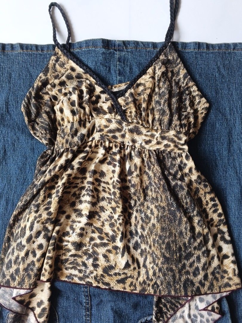 Leopard Print Camisole Spaghetti Strap Top Y2K (Category: Sleeveless) located in Batangas. Submitted by _mistybleu16 (Listing ID 1466617007, Image 2). Description: - Trendy leopard print camisole top - Stylish black braided spaghetti straps & V-neckline - Flattering empire waist with a flowy, asymmetrical handkerchief hem - Lightweight, silky-soft fabric for ultimate comfort - Versatile piece: great for layering or solo wear in warm weather - Mod