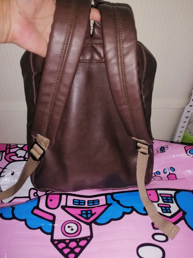 Leslie Club Brown Leather Backpack Ace Co Ltd (Category: Backpacks) located in Quezon City. Submitted by rolenalma (Listing ID 1466580846, Image 2). Description: - Brand: Leslie Club (Ace Co Ltd) - Material: Brown faux leather with durable fabric lining - Compartments: Secure top main zipper and handy front zip pocket - Comfort & Carry: Adjustable beige straps and sturdy top grab handle - Condition: Clean overall with minimal wear - Origin: Made 