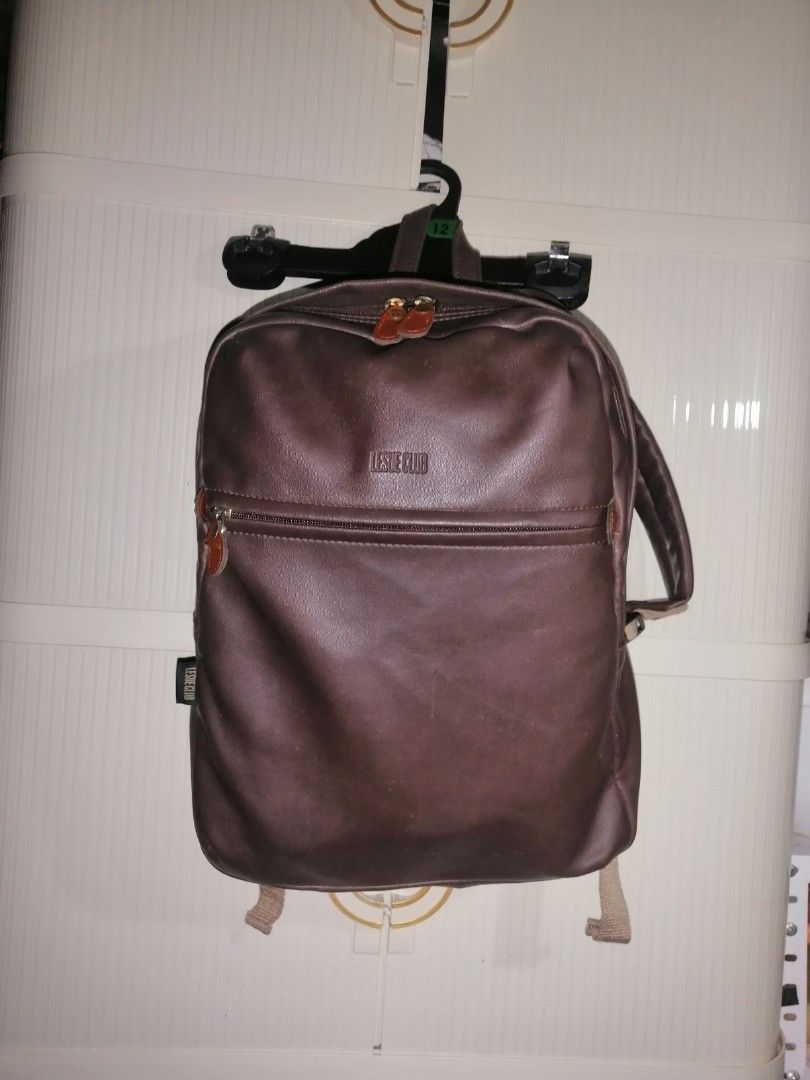 Leslie Club Brown Leather Backpack Ace Co Ltd (Category: Backpacks) located in Quezon City. Submitted by rolenalma (Listing ID 1466580846, Image 1). Description: - Brand: Leslie Club (Ace Co Ltd) - Material: Brown faux leather with durable fabric lining - Compartments: Secure top main zipper and handy front zip pocket - Comfort & Carry: Adjustable beige straps and sturdy top grab handle - Condition: Clean overall with minimal wear - Origin: Made 