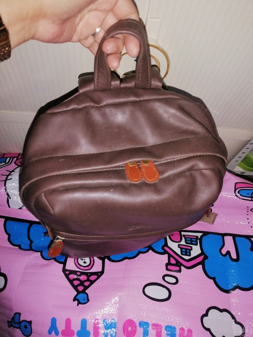 Leslie Club Brown Leather Backpack Ace Co Ltd (Category: Backpacks) located in Quezon City. Submitted by rolenalma (Listing ID 1466580846, Image 3). Description: - Brand: Leslie Club (Ace Co Ltd) - Material: Brown faux leather with durable fabric lining - Compartments: Secure top main zipper and handy front zip pocket - Comfort & Carry: Adjustable beige straps and sturdy top grab handle - Condition: Clean overall with minimal wear - Origin: Made 