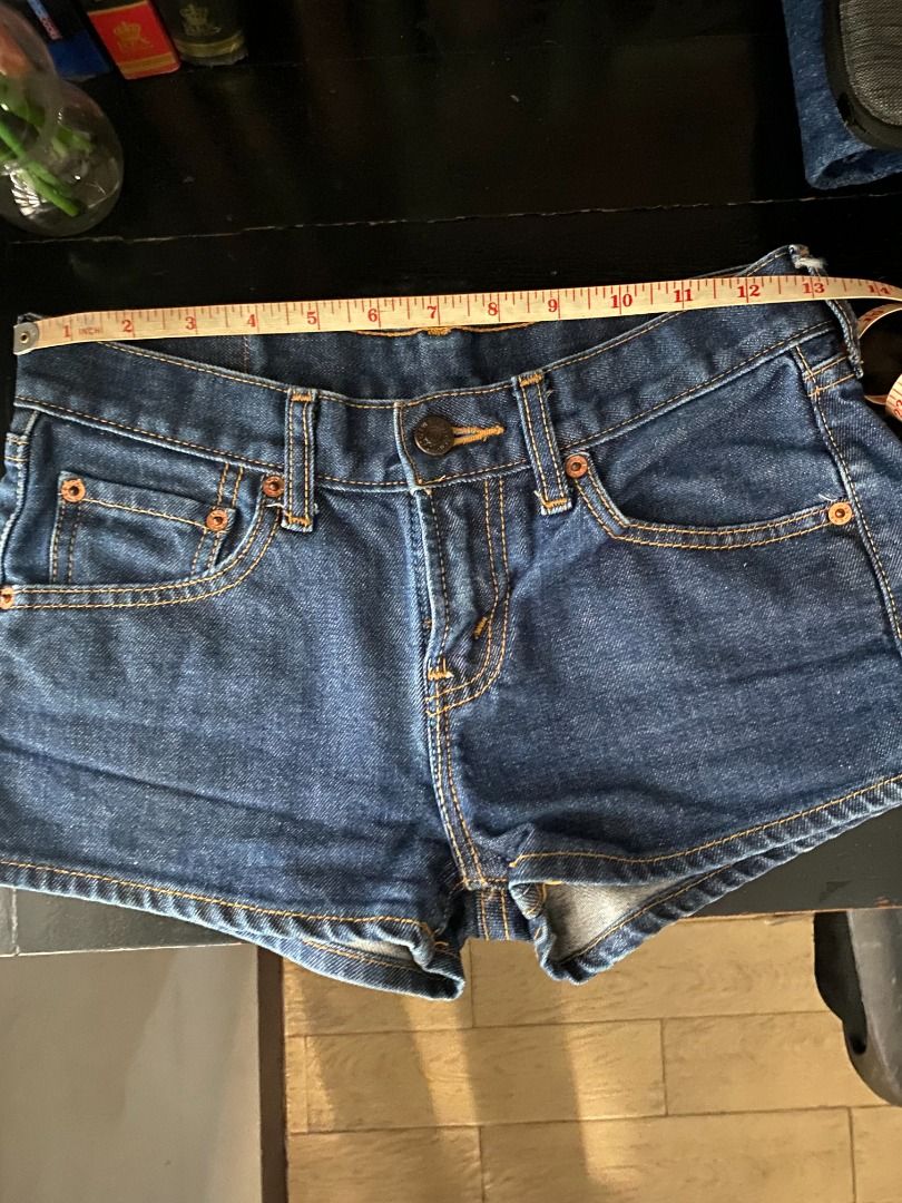 Levi's Y2K micro denim shorts (Category: Shorts) located in Quezon City. Submitted by clementin_e (Listing ID 1466609697, Image 2). Description: - Brand: Levi's - Wash: Medium blue with dark contrast stitching - Fit: Mid-rise with traditional five-pocket styling - Details: Frayed raw hem, metal button closure, classic red tab, and back leather waist patch - Length: Approx. 9.5 inches (side seam) - Condition: Excellent pre-loved condition, ready t