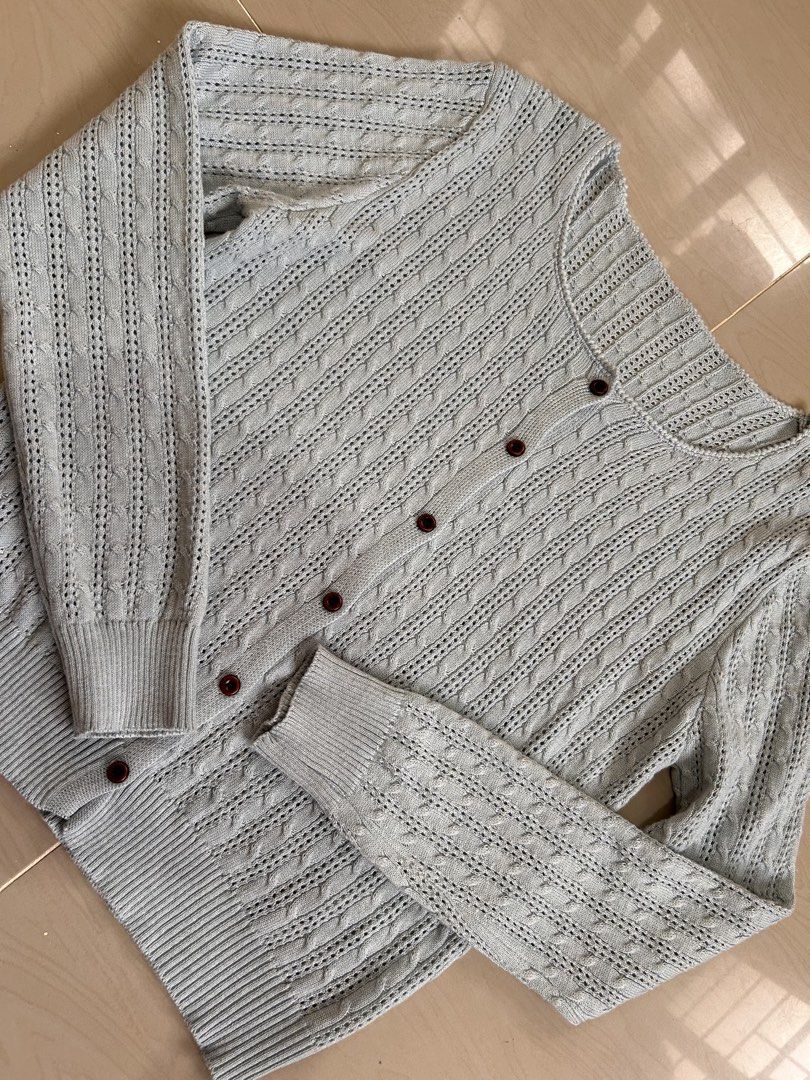 Light Blue Knit Cardigan (Category: Coats, Jackets and Outerwear) located in Caloocan City. Submitted by declutterieee (Listing ID 1466594630, Image 1). Description: - Color: Light Blue - Style: Classic cable knit cardigan with long sleeves - Neckline: Scoop neck with dark brown front buttons - Details: Ribbed cuffs and hemline - Condition: Clean and ready to wear - Med to Large.