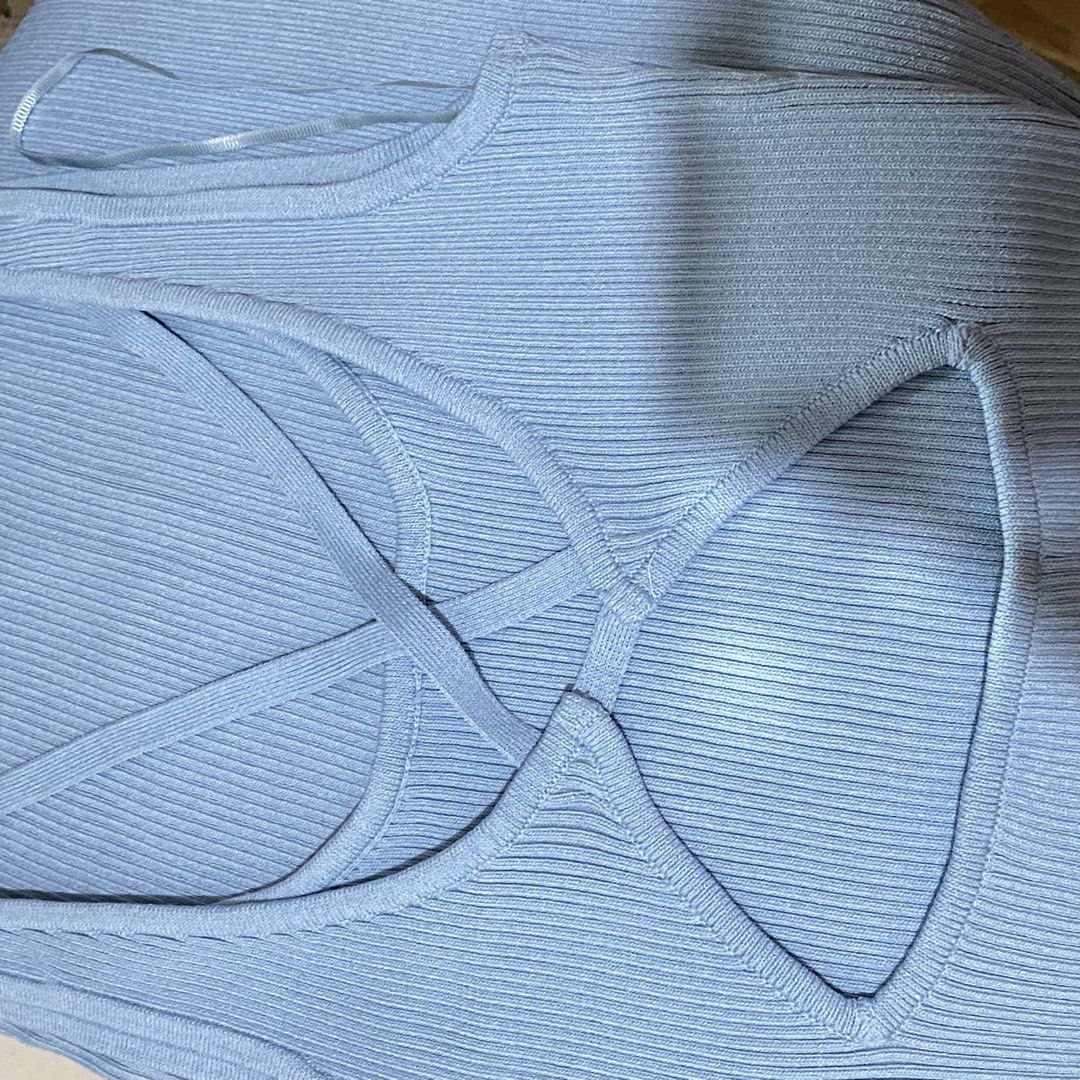 Light blue ribbed dress (Category: Sleeveless) located in Cavite. Submitted by helloize (Listing ID 1466618279, Image 2). Description: - Color: Light blue - Material: Soft, stretchy ribbed knit - Design: Unique crisscross strap on the front chest - Fit: Sleeveless and fitted silhouette - Condition: Clean and well-kept - Styling: Great basic for layering or wearing on warm days with crisscross back straps above the knee length Never nagamit since 