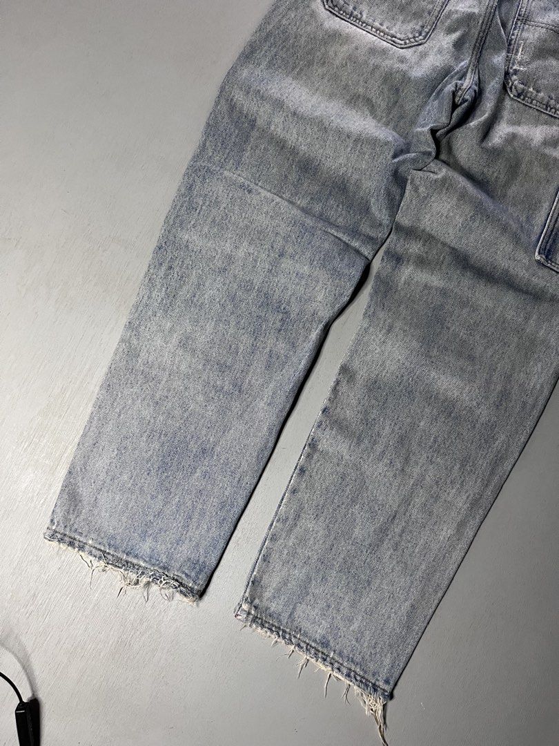 Light wash carpenter denim jeans with distressed hems (Category: Jeans) located in Catbalogan. Submitted by yellfindss (Listing ID 1466751021, Image 3). Description: - Style: Streetwear relaxed fit carpenter jeans -30-32/41 lo 7 - Wash: Light wash denim - Details: Double-knee panels, utility pockets, and a back leather patch - Finishing: Distressed front panels and frayed hems.