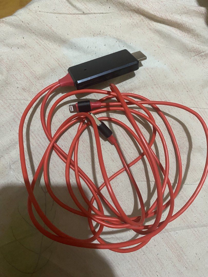 Lightning to HDMI Adapter Cable Red (Category: Cables & Adaptors) located in Manila. Submitted by darleenara75642 (Listing ID 1466698149, Image 1). Description: - Red Lightning to HDMI adapter cable with built-in USB power connector - Easily connects iPhone or iPad directly to TVs, projectors, or monitors - Features a durable, long red cable for flexible setup - Tested and 100% working condition - Perfect for streaming movies, viewing photos, or 