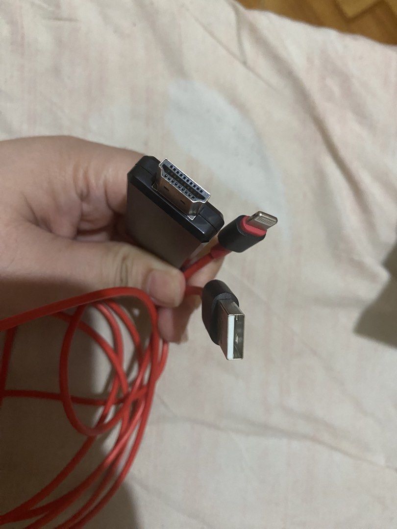 Lightning to HDMI Adapter Cable Red (Category: Cables & Adaptors) located in Manila. Submitted by darleenara75642 (Listing ID 1466698149, Image 2). Description: - Red Lightning to HDMI adapter cable with built-in USB power connector - Easily connects iPhone or iPad directly to TVs, projectors, or monitors - Features a durable, long red cable for flexible setup - Tested and 100% working condition - Perfect for streaming movies, viewing photos, or 
