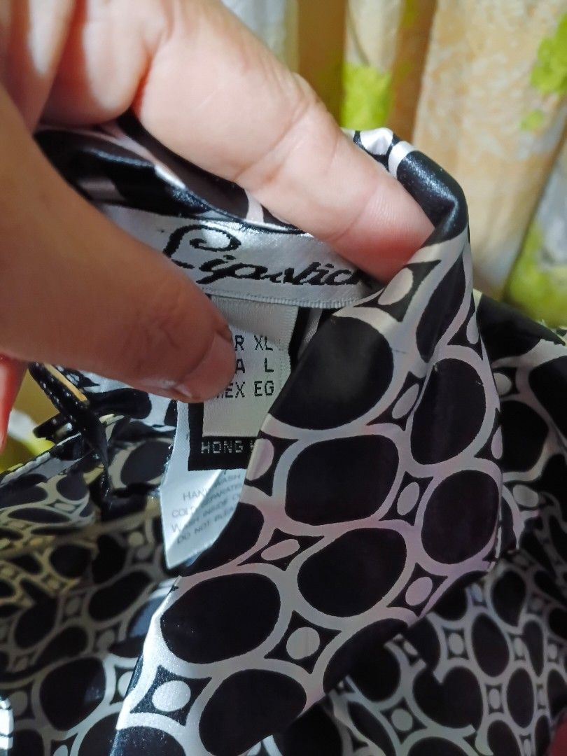Lipstick Black White Geometric Pattern Blouse (Category: Blouses) located in Quezon City. Submitted by bangbang_87 (Listing ID 1466701735, Image 3). Description: - Brand: Lipstick - Design: Black and white geometric circle print - Details: High neckline with back button closure, long sleeves with gathered details - Fabric: Smooth with a slight sheen - Size: EUR XL, USA L - Origin: Made in Hong Kong.