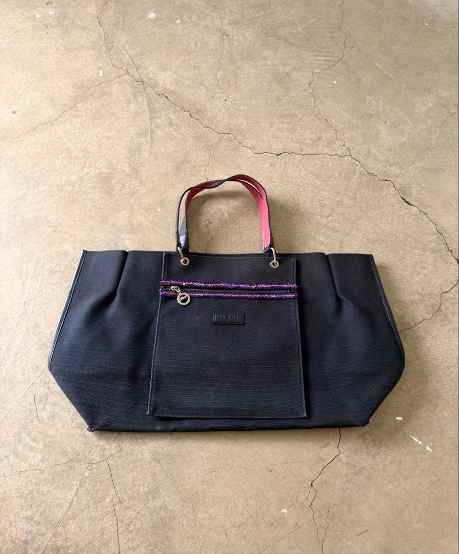 Longchamp Black Canvas Tote Bag with Sequin Zip Pocket (Category: Tote Bags) located in Alfonso. Submitted by jbcamet (Listing ID 1466567085, Image 1). Description: - Brand: Longchamp - Style: Canvas tote bag in classic black - Interior: Vibrant contrast pink lining with matching leather strap undersides - Details: Front exterior pocket with sparkly blue and red sequin trim - Hardware: Silver-tone with iconic Longchamp horse logo zipper pull (sta