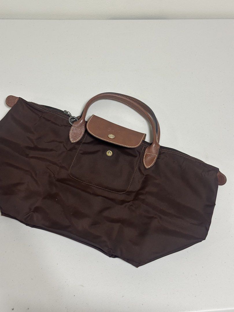 Longchamp Le Pliage Brown Nylon Foldable Tote Bag (Category: Luxury Bags & Wallets) located in Bacoor. Submitted by krsha_al (Listing ID 1466767938, Image 2). Description: As is where is, actual pictures posted Short handle in medium size.