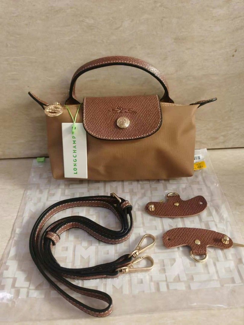 Longchamp Le Pliage Extra Small Handbag Various Colors (Category: Luxury Bags & Wallets) located in Manila. Submitted by jonalyn19 (Listing ID 1466649732, Image 3). Description: - Authentic Longchamp mini top handle bag - Available in multiple colors - Material: Nylon body with signature leather flap and handles - Includes removable shoulder strap for versatile wear - Complete with tag and dust bag - Perfect compact size for daily essentials or q