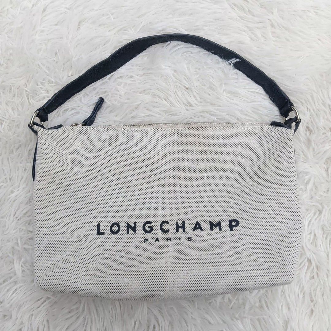 Longchamp Paris Canvas Handbag (Category: Luxury Bags & Wallets) located in Gattaran. Submitted by thrift_wiseph (Listing ID 1466678920, Image 1). Description: - Brand: Longchamp Paris - Color: Off-white canvas with striking black branding and black leather handle - Closure: Secure top zipper closure - Interior: Brown fabric lining with an extra zippered pocket for organization - Authenticity: Features interior leather tag reading 'Longchamp 1948
