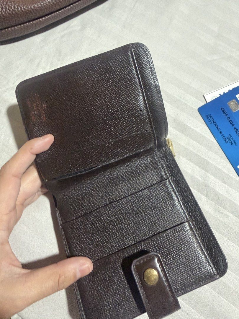 Louis Vuitton Damier Ebene Compact Wallet (Category: Luxury Bags & Wallets) located in Davao. Submitted by ketfong (Listing ID 1466591629, Image 3). Description: Louis Vuitton wallet in Damier Ebene canvas with brown leather snap closure tab. Classic checkered brown pattern on exterior. Interior includes multiple card slots and a side zip pocket for coins. Compact fold design, fits easily into bags or pockets. Gold-tone hardware zipper pull with 