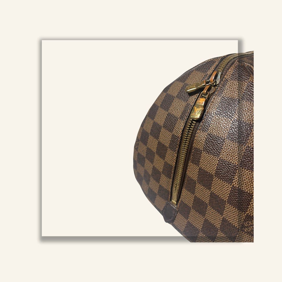 Louis Vuitton Damier Ebene Handbag (Category: Luxury Bags & Wallets) located in Manila. Submitted by fromsoleil (Listing ID 1466686060, Image 2). Description: - Authentic Louis Vuitton handbag in iconic Damier Ebene canvas - Features dark brown leather handles and gold-tone hardware with minor tarnishing from age - Secure double zipper top closure - Spacious interior lined with red textile, complete with a convenient slip pocket - Excellent struc