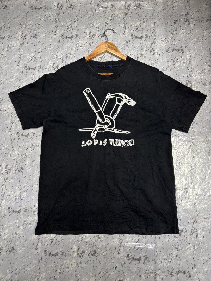 Louis Vuitton Graphic T-Shirt Black (Category: Activewear) located in Manila. Submitted by raven236 (Listing ID 1466721005, Image 1). Description: - Brand: Louis Vuitton - Color: Deep black with maintained color - Fit: Regular fit, short-sleeve crewneck - Design: White tools graphic and brand lettering on front - Detail: Small white trunk graphic near the upper back collar - Condition: Clean, well-maintained overall.