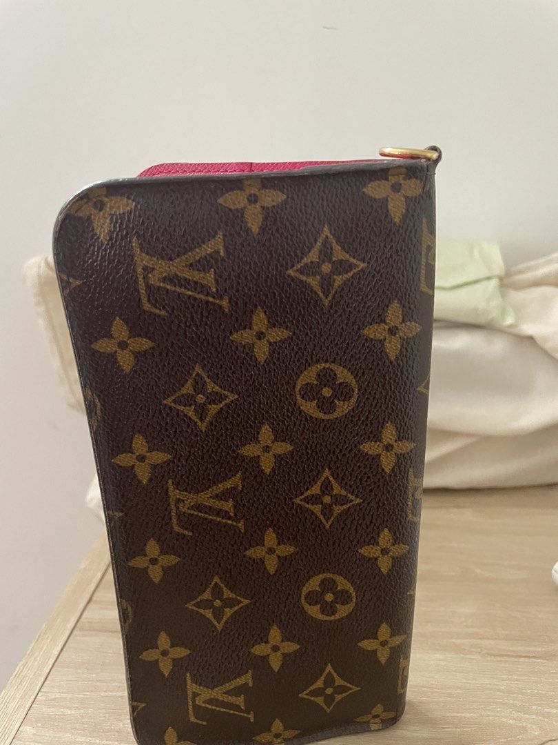 Louis Vuitton Monogram Canvas Long Wallet with Pink Interior (Category: Luxury Bags & Wallets) located in Cordova. Submitted by fiercedragon.47e450 (Listing ID 1466592721, Image 3). Description: - Authentic Louis Vuitton monogram canvas wallet - Eye-catching vibrant pink leather interior lining - Secure snap button closure on both ends - Zippered compartment with gold-tone hardware and dual zipper pulls - Convenient side D-ring for attaching stra