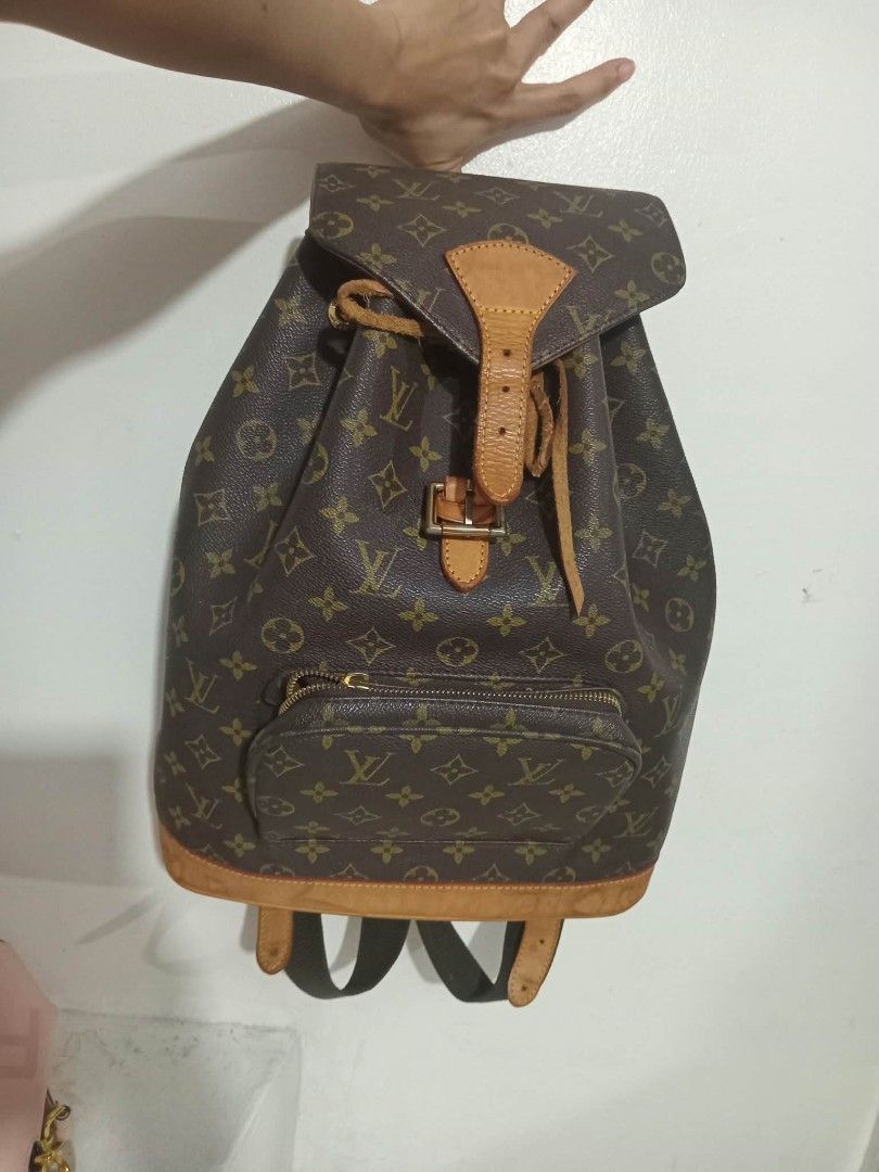 Louis Vuitton Monogram Leather Backpack (Category: Backpacks) located in Urdaneta. Submitted by assortedprelovedd (Listing ID 1466696068, Image 1). Description: - Authentic Louis Vuitton monogram coated canvas backpack - Vachetta leather trim with drawstring and buckle flap closure - Convenient front zip pocket for quick-access items - Adjustable shoulder straps for comfortable wear - Beautiful natural patina on leather parts from normal use - Sp