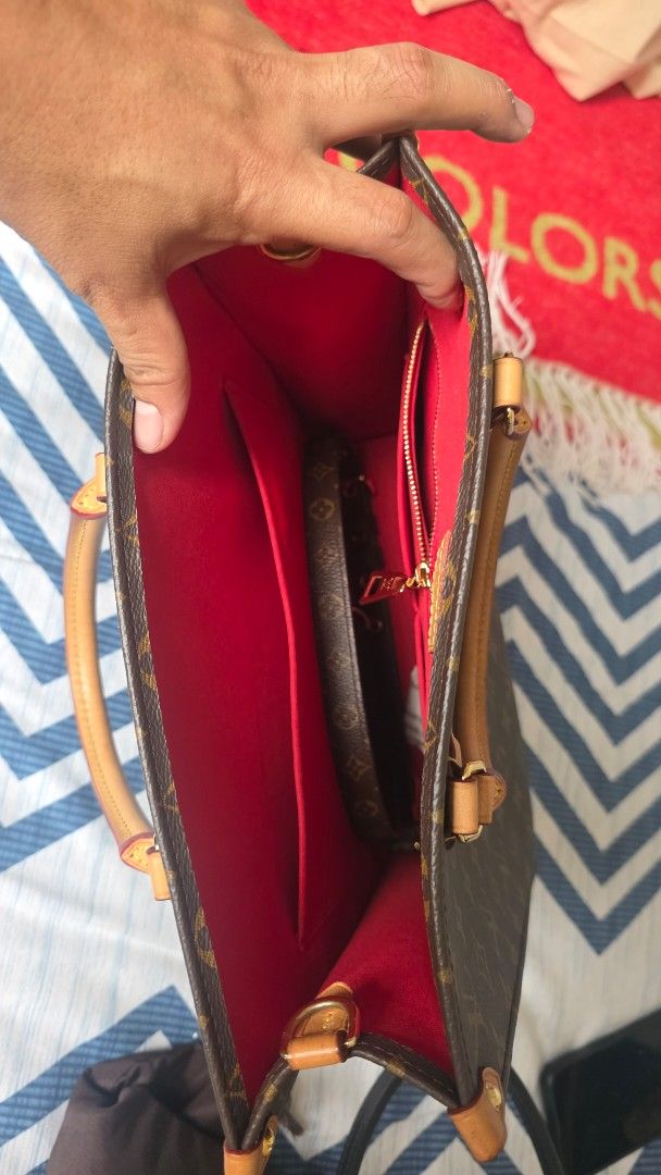 Louis Vuitton Sac Plat PM (Category: Luxury Bags & Wallets) located in Makati City. Submitted by jadulanju71818 (Listing ID 1466576117, Image 3). Description: - Authentic Louis Vuitton monogram tote bag in classic brown - Vibrant red fabric interior with multiple compartments and a secure zip pocket - Classic structured shape with premium gold-tone hardware - Comfortable vachetta leather top handles - Includes matching monogram shoulder strap for
