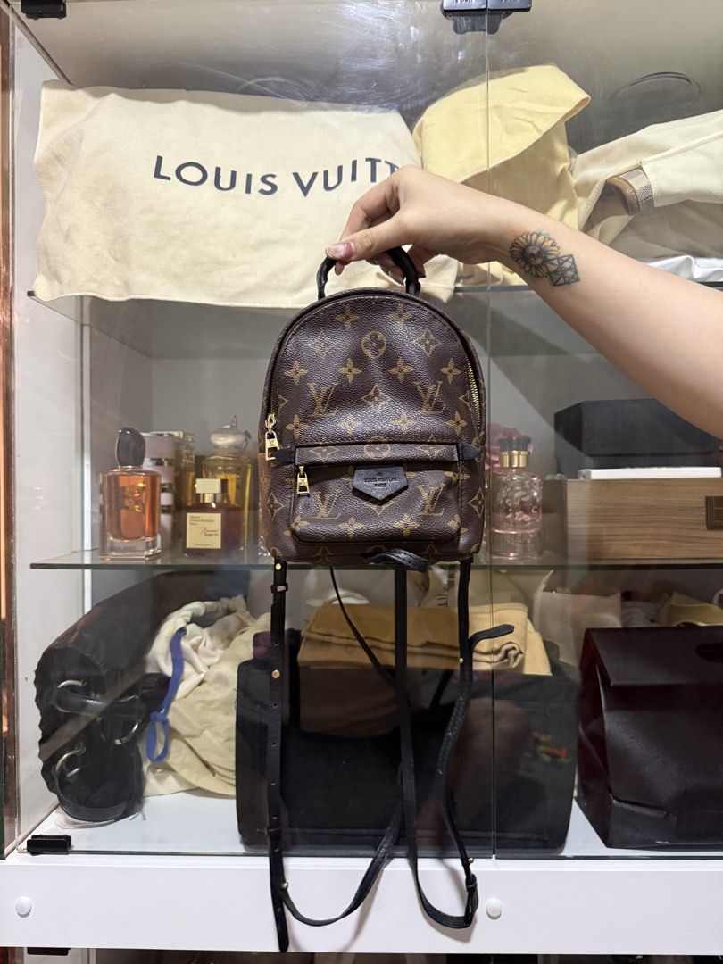 Louis Vuitton Palm Springs Mini Monogram Canvas Backpack (Category: Luxury Bags & Wallets) located in Caloocan City. Submitted by kimmndza_176 (Listing ID 1466740739, Image 1). Description: - not guaranteed Brand: Louis Vuitton - Style: Monogram canvas mini backpack - Color/Material: Dark brown monogram print with black leather trim - Hardware: Gold-tone - Features: Front zippered pocket with LV signature patch, adjustable black leather straps, a