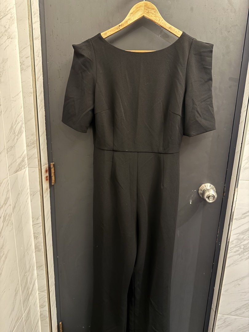 Love Bonito Black Jumpsuit (Category: Jumpsuits) located in Makati City. Submitted by 099baby (Listing ID 1466694377, Image 2). Description: Brand new Love Bonito black jumpsuit in Size M (UK 10 / US 6) with tag attached. Features short sleeves, padded shoulders, straight-cut pants, and a V-neck back with a concealed zip. 🤍 Originally bought on the Love Bonito website for PHP2,869 🤍 With a hole (maybe 2 inches big) but can easily be fixed — as 