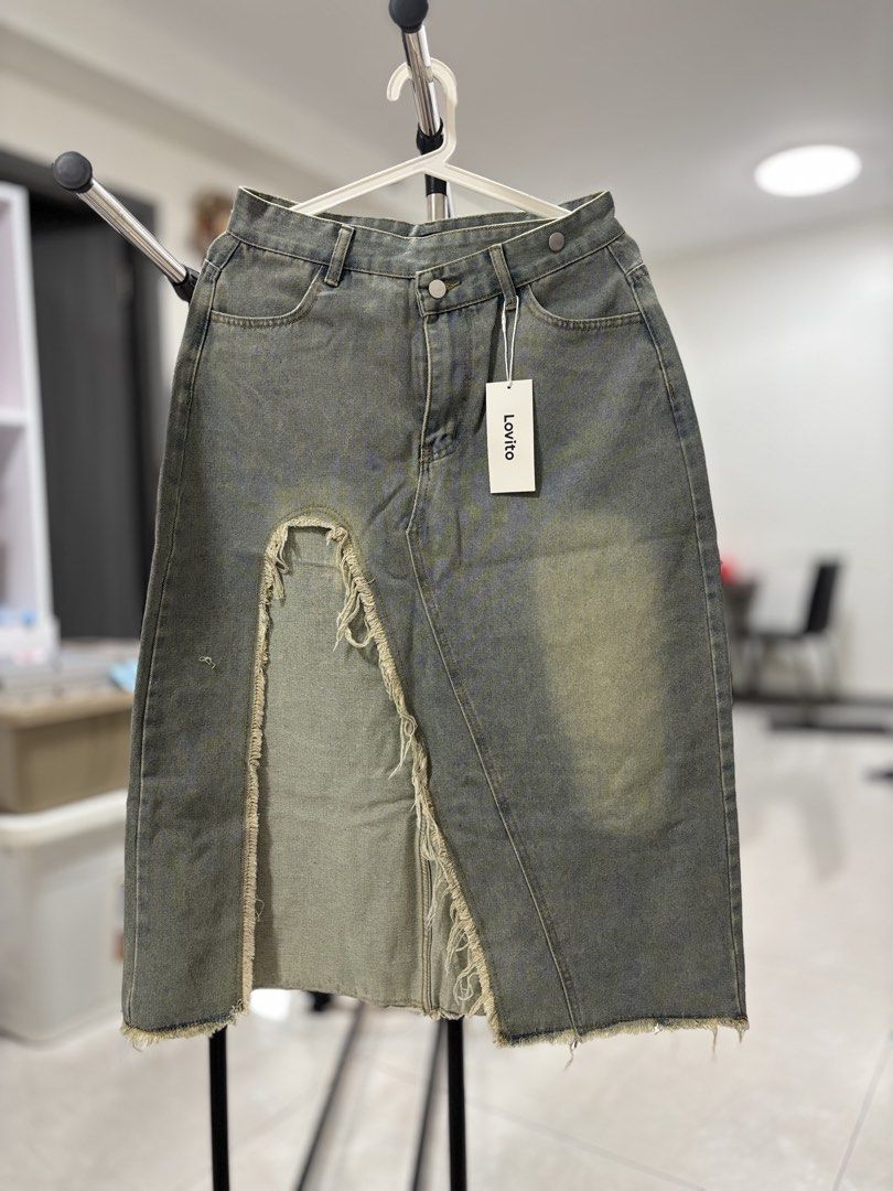 Lovito Denim Split Midi Skirt Size L (Category: Skirts) located in Pasay City. Submitted by altheatheaaeia (Listing ID 1466683049, Image 1). Description: - Brand: Lovito - Item: Denim midi skirt - Color/Wash: Grey wash with vintage fading - Size: L (EU 38, S 8) - Details: High waist, button fly, front slit with raw frayed edges - Condition: Brand new with tags attached.
